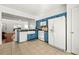 Well-lit kitchen features blue cabinets, white appliances, tile backsplash, and a farmhouse style sink at 208 Kenninghall Ln # 627, Smyrna, GA 30082