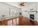 Living room with hardwood floors, a ceiling fan, and a fireplace with a decorative mantle at 208 Kenninghall Ln # 627, Smyrna, GA 30082