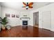 Living room featuring hardwood floors, a ceiling fan, a fireplace, and a decorative mantle at 208 Kenninghall Ln # 627, Smyrna, GA 30082