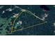 Aerial view showcases the parcel of land, surrounded by trees with established homes at 110 Cove Ln, Social Circle, GA 30025