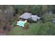 An aerial view showcasing the home's backyard, featuring a refreshing pool and lush greenery at 110 Cove Ln, Social Circle, GA 30025