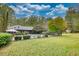 Spacious backyard with a pool, lush lawn, and mature trees with fencing, for outdoor enjoyment and recreation at 110 Cove Ln, Social Circle, GA 30025