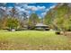 Large backyard featuring a lawn, pool, and mature trees at 110 Cove Ln, Social Circle, GA 30025