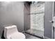 Bathroom featuring a gray tiled shower and toilet at 110 Cove Ln, Social Circle, GA 30025