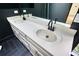 Bathroom with a double sink vanity, dark walls, and tile floors at 110 Cove Ln, Social Circle, GA 30025