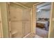 Bathroom featuring a shower with sliding glass door and an open doorway to the bedroom with ceiling fan at 110 Cove Ln, Social Circle, GA 30025