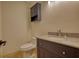 Updated bathroom featuring a vanity with granite countertops and cabinet with an above-the-toilet cabinet at 110 Cove Ln, Social Circle, GA 30025
