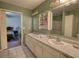 Bathroom featuring dual sinks, a vanity and a large mirror, and a shower with sliding glass doors at 110 Cove Ln, Social Circle, GA 30025