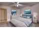 Staged bedroom featuring blue accents, ocean art, lamps, and a dresser at 110 Cove Ln, Social Circle, GA 30025