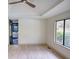 Bedroom with a tray ceiling, hardwood floors, and view to the ensuite bathroom at 110 Cove Ln, Social Circle, GA 30025