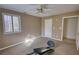 A bedroom featuring carpet floors, ceiling fan, natural light and ample space for exercise equipment at 110 Cove Ln, Social Circle, GA 30025