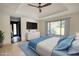 Staged bedroom with hardwood floors, television, and view to ensuite bathroom at 110 Cove Ln, Social Circle, GA 30025