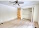 Bright bedroom features neutral walls, wood floors, ceiling fan, and closet with open bi-fold doors at 110 Cove Ln, Social Circle, GA 30025