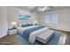 Bright bedroom boasts stylish furnishings, hardwood floors, natural light, and coastal decor at 110 Cove Ln, Social Circle, GA 30025