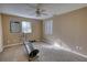 A bedroom featuring carpet floors, ceiling fan, natural light and ample space for exercise equipment at 110 Cove Ln, Social Circle, GA 30025