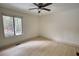 Bright bedroom with a ceiling fan, and a large window at 110 Cove Ln, Social Circle, GA 30025
