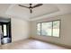 Bright bedroom featuring a ceiling fan, large window, and hardwood floors at 110 Cove Ln, Social Circle, GA 30025