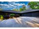 Modern home featuring a long driveway and two car garage with manicured landscaping at 110 Cove Ln, Social Circle, GA 30025