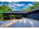 Modern home featuring a long driveway and two car garage with manicured landscaping at 110 Cove Ln, Social Circle, GA 30025