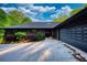 Modern home featuring a long driveway and two car garage with manicured landscaping at 110 Cove Ln, Social Circle, GA 30025