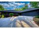 Modern home featuring a long driveway and two car garage with manicured landscaping at 110 Cove Ln, Social Circle, GA 30025