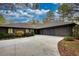 Charming single-story home featuring a spacious driveway and attached garage, surrounded by lush landscaping at 110 Cove Ln, Social Circle, GA 30025