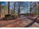 Secluded home on a tree-covered lot with a winding driveway and lush landscaping at 110 Cove Ln, Social Circle, GA 30025