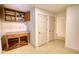 Hallway with a built-in cabinet and countertop, beige tile floor and access to other rooms at 110 Cove Ln, Social Circle, GA 30025