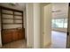Hallway features built-in cabinet for extra storage leading to a spacious room with multiple windows and views at 110 Cove Ln, Social Circle, GA 30025