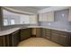 Kitchen featuring modern countertops, two-tone cabinets, and stainless steel sink beneath a sunlit window at 110 Cove Ln, Social Circle, GA 30025