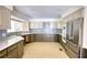 Bright kitchen featuring stainless steel appliances, modern countertops and cabinets, and tile flooring at 110 Cove Ln, Social Circle, GA 30025