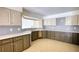 Spacious kitchen with light countertops, stylish backsplash, and two-tone cabinets, offering modern appeal at 110 Cove Ln, Social Circle, GA 30025