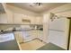 Functional kitchen design featuring white appliances, tile floors, and a green countertop at 110 Cove Ln, Social Circle, GA 30025