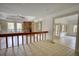 Bright living area featuring a stone fireplace, modern fan, and ample natural light at 110 Cove Ln, Social Circle, GA 30025
