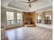 Living room featuring a stone fireplace, ceiling fan, and shuttered windows at 110 Cove Ln, Social Circle, GA 30025