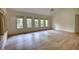 Bright, spacious living area with vaulted ceiling, ample natural light, and wood-look flooring, awaiting personalization at 110 Cove Ln, Social Circle, GA 30025
