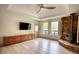 Modern living room with stone fireplace, wood flooring, and custom cabinets at 110 Cove Ln, Social Circle, GA 30025
