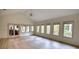 Spacious living area with vaulted ceilings, ceiling fan, and multiple windows providing ample natural light and serene views at 110 Cove Ln, Social Circle, GA 30025