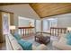 Staged living room featuring wood ceiling, modern flooring, and comfortable seating at 110 Cove Ln, Social Circle, GA 30025