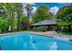 Beautiful pool view with a home, complemented by a lush green yard for outdoor enjoyment at 110 Cove Ln, Social Circle, GA 30025