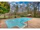 Backyard in-ground pool with patio area, perfect for outdoor relaxation and entertaining, surrounded by mature trees at 110 Cove Ln, Social Circle, GA 30025