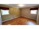 Cozy bedroom with hardwood floors, natural light, and neutral walls at 2479 Landeau Cir, Tucker, GA 30084