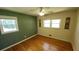 Bright bedroom featuring a ceiling fan, hardwood floors, and plenty of natural light at 2479 Landeau Cir, Tucker, GA 30084