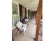 Relaxing front porch with white wicker chair and black shutters at 2479 Landeau Cir, Tucker, GA 30084