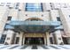 An elaborate hotel facade with an arched entrance, stone columns, and ornamental lettering at 75 14Th Ne St # 3820, Atlanta, GA 30309