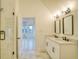 This bathroom has a double vanity, tile flooring, and a glass shower with a view to another room at 290 2Nd St, Fayetteville, GA 30214