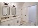 Modern bathroom features a double vanity with stylish mirrors and fixtures, and tile flooring at 290 2Nd St, Fayetteville, GA 30214