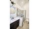 Modern bathroom features a single vanity, a glass shower, tile floor, and sleek fixtures at 290 2Nd St, Fayetteville, GA 30214