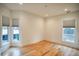 Bright bedroom with hardwood floors and lots of natural light from large windows at 290 2Nd St, Fayetteville, GA 30214