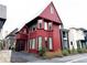 Two-story red home boasting unique architectural details and a well-maintained front yard at 290 2Nd St, Fayetteville, GA 30214